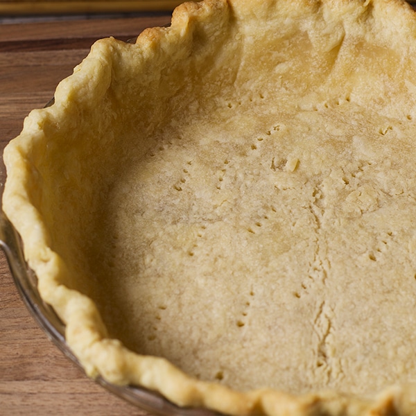 The bottom pie crust in a pie plate, ready to bake.