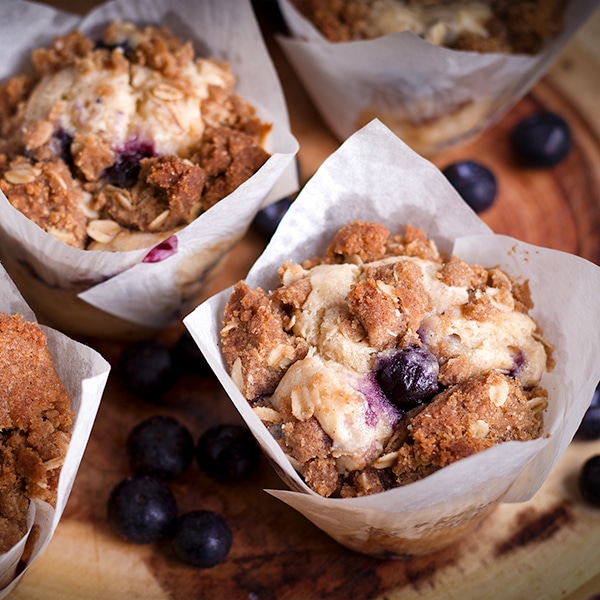 A tray of warm sour cream blueberry muffins with brown sugar streusel.