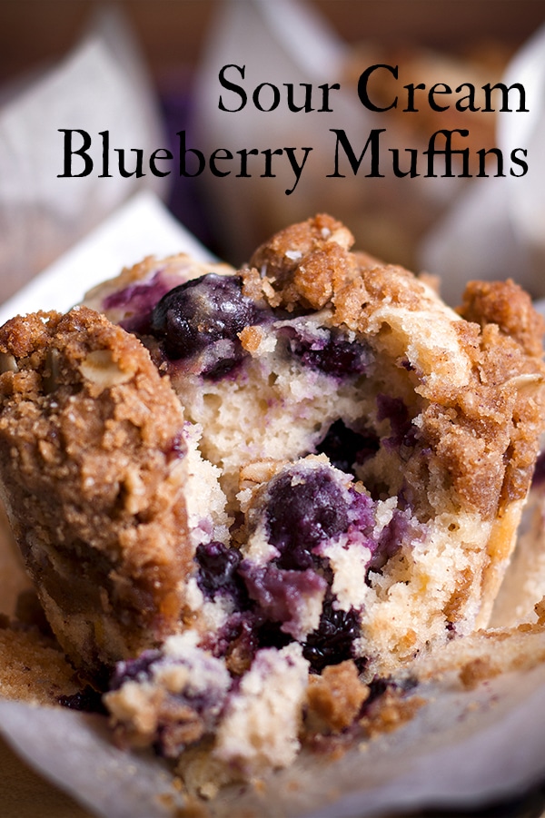 A blueberry muffin with streusel broken apart so you can see the middle.
