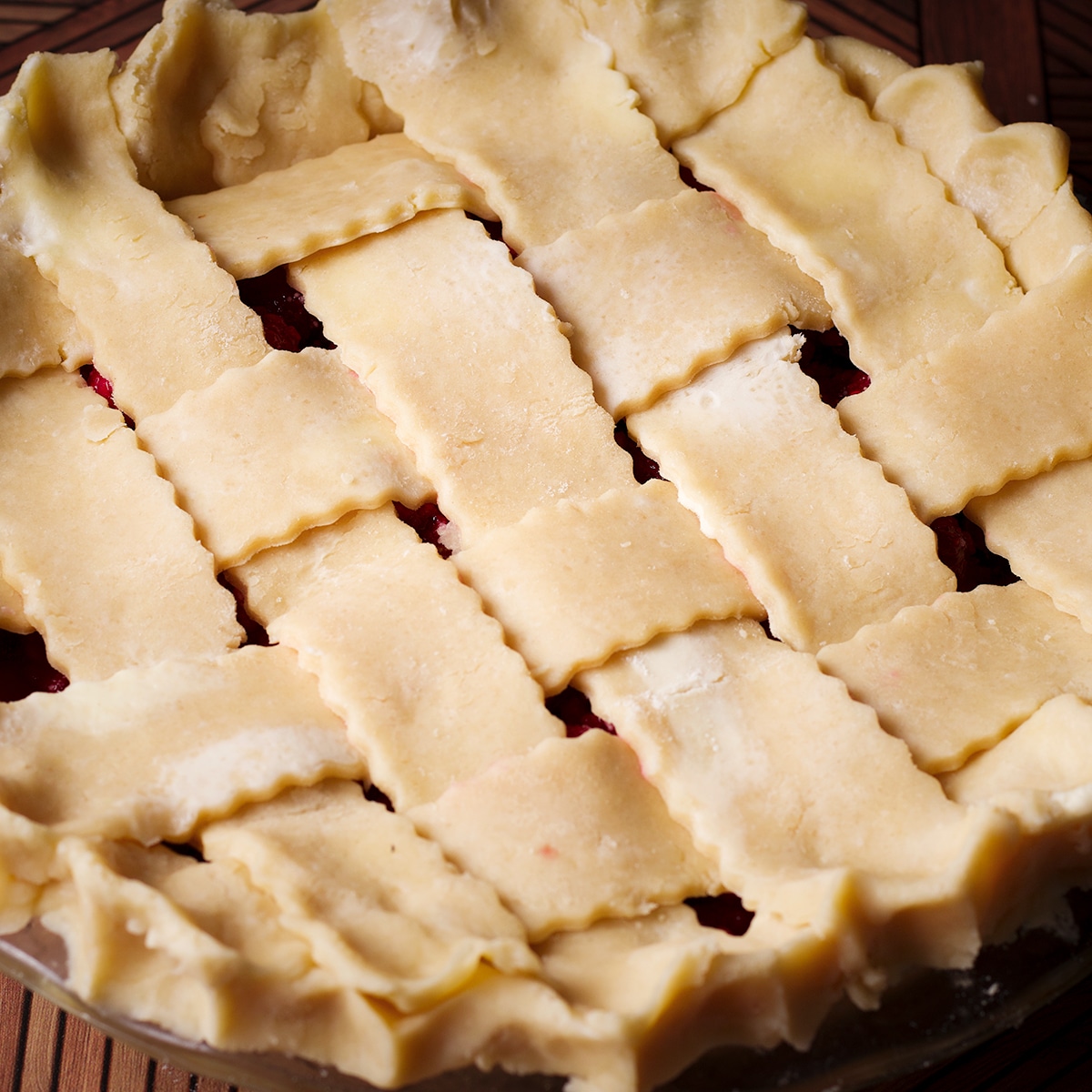 Crimping the edges of a pie crust topped with a lattice crust.