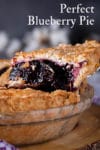 Serving a slice of homemade double crust blueberry pie.