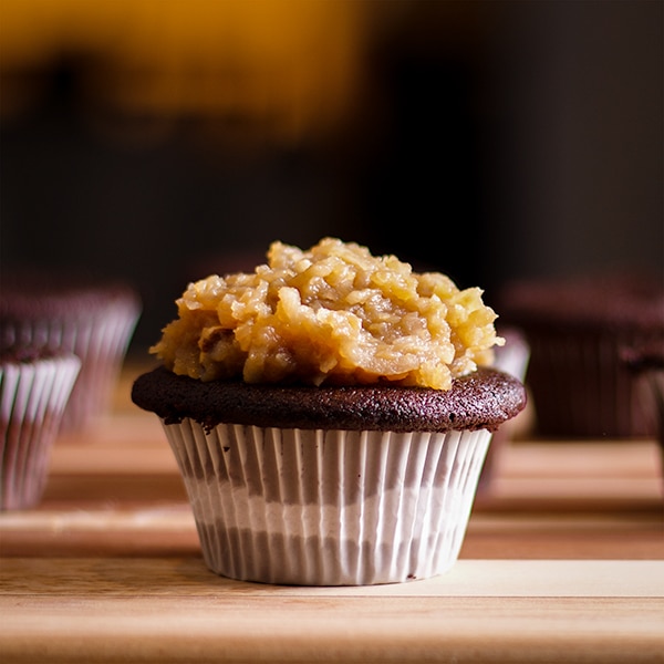 A German Chocolate Cupcake topped with caramel coconut and pecan topping.