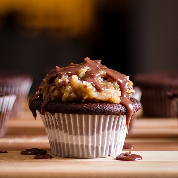 Chocolate ganache dripping from the top of a German Chocolate Cupcake.