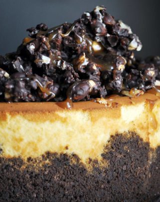 Peanut Butter Cheesecake with chocolate peanut butter crunch topping | ofbatteranddough.com