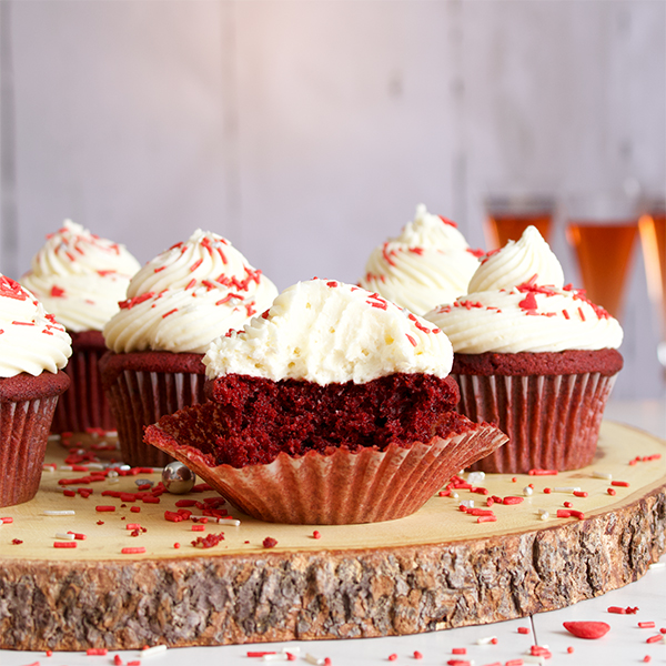 The inside of a red velvet cupcake with cream cheese buttercream.