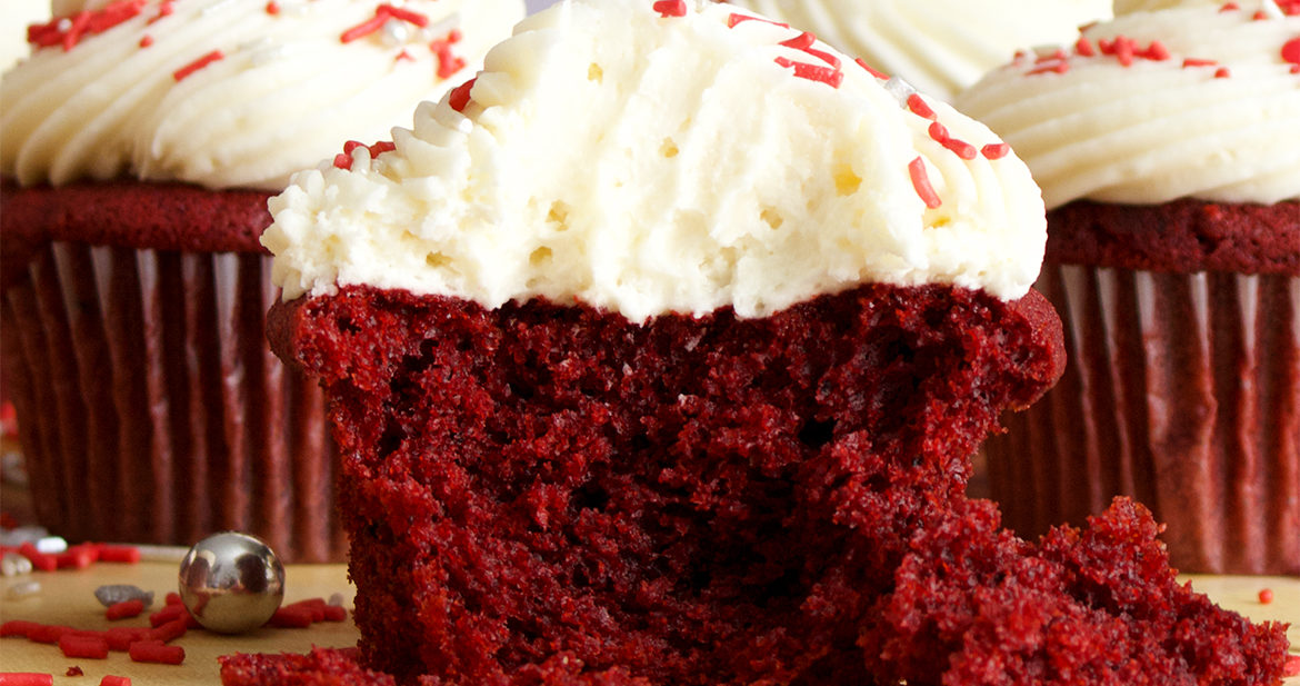 The inside of a red velvet cupcake with cream cheese buttercream.