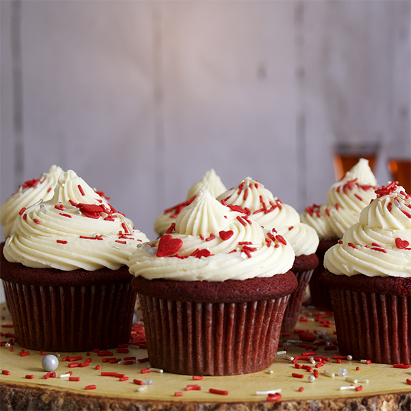 Red velvet cupcakes with cream cheese buttercream with sprinkles.