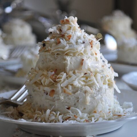 A mini Coconut Layer Cake frosted with Maple Italian Meringue Buttercream.