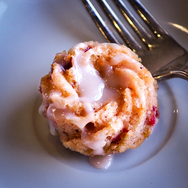 One mini Cranberry Bundt Cake on a plate with a fork.