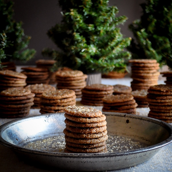 Several stacks of small chewy ginger snap cookies.