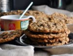 A stack of giant chewy oatmeal raisin cookies. | ofbatteranddough.com