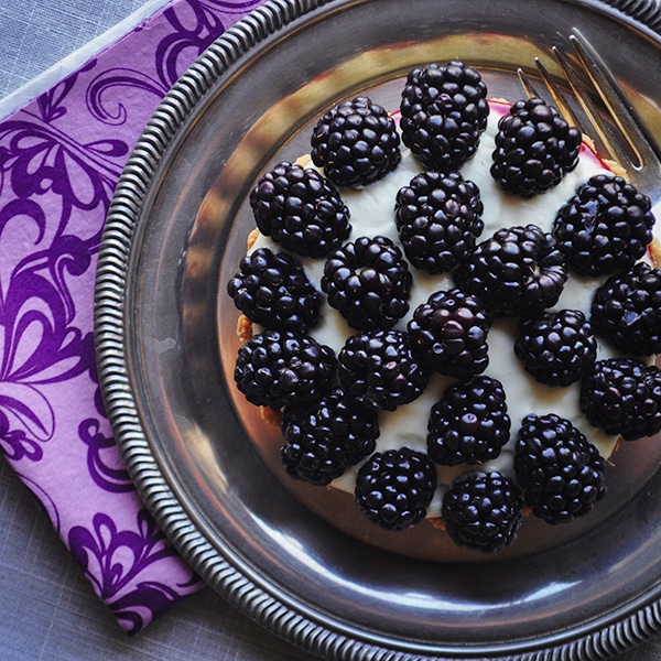 A close-up picture of a blackberry custard fruit tart with amaretto