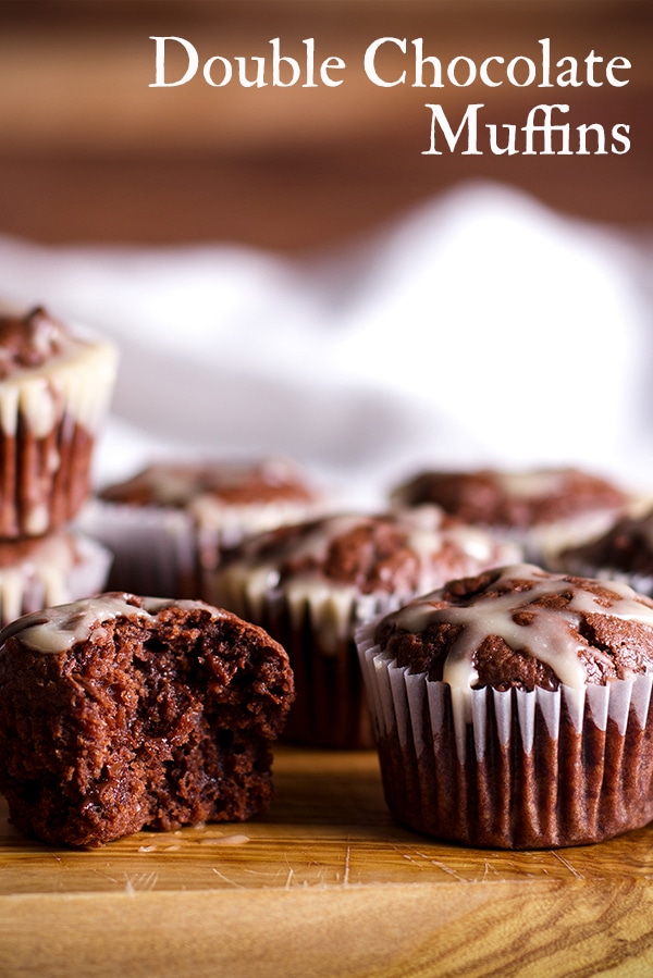 A tray of mini chocolate muffins with vanilla glaze.
