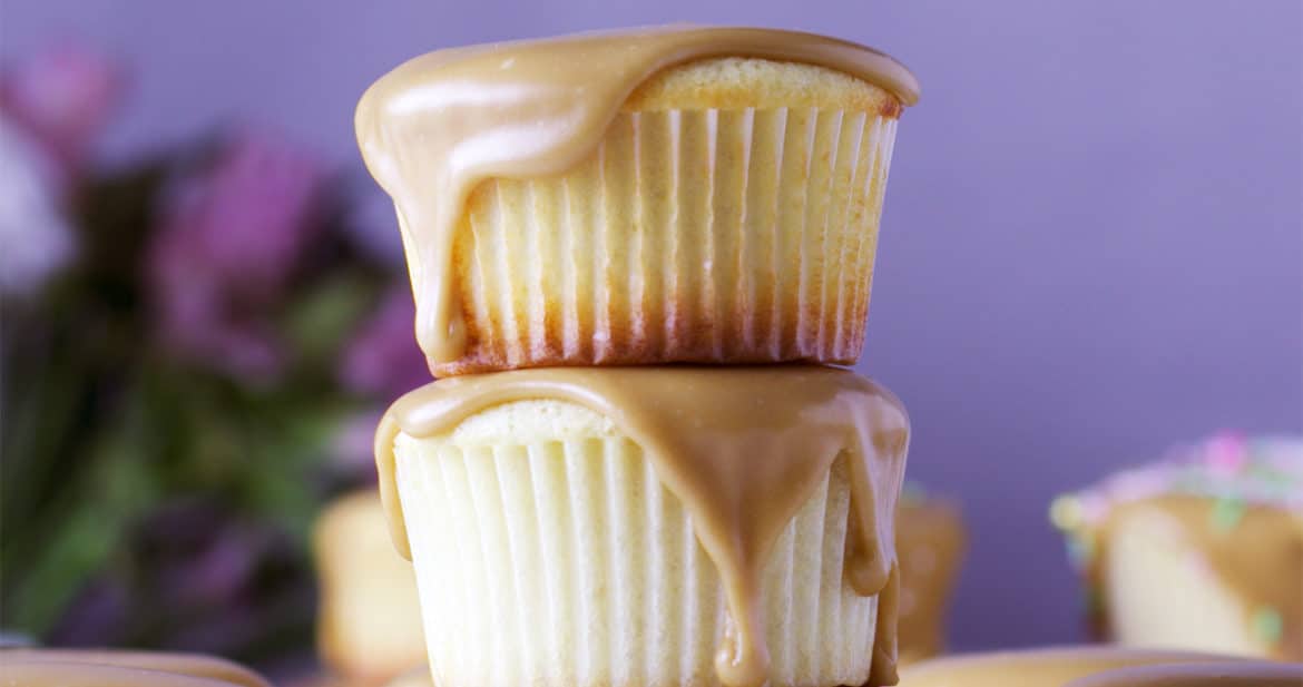 A stack of three Perfect buttermilk caramel cupcakes with caramel frosting