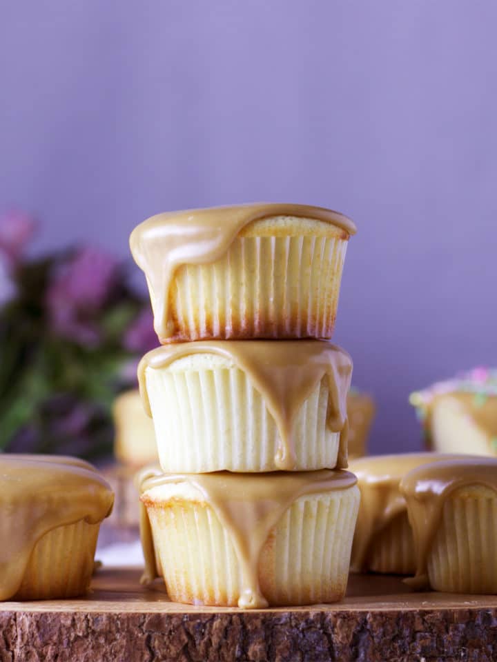 A stack of three Perfect buttermilk caramel cupcakes with caramel frosting