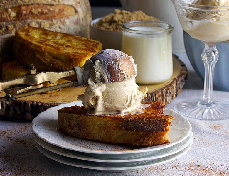 Scooping French Toast ice cream onto a piece of French toast.
