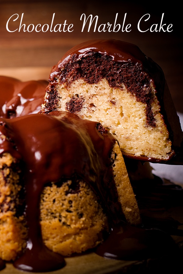 Serving a slice of marble cake covered in chocolate glaze.