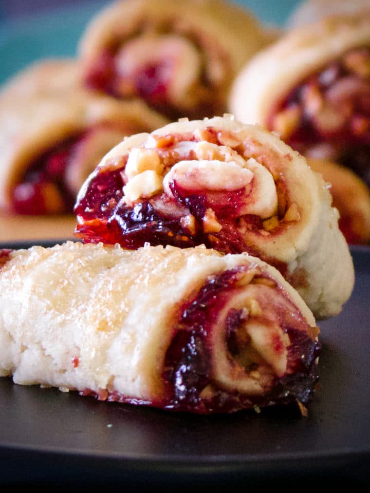 A plate of two cherry almond rugelach cookies.