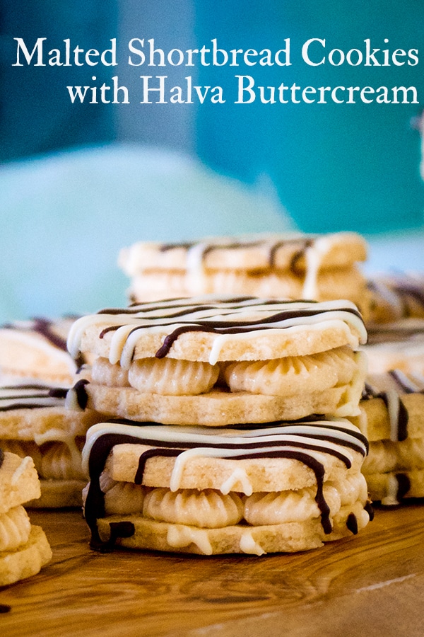 A tray of white chocolate malted shortbread sandwich cookies filled with halva buttercream.