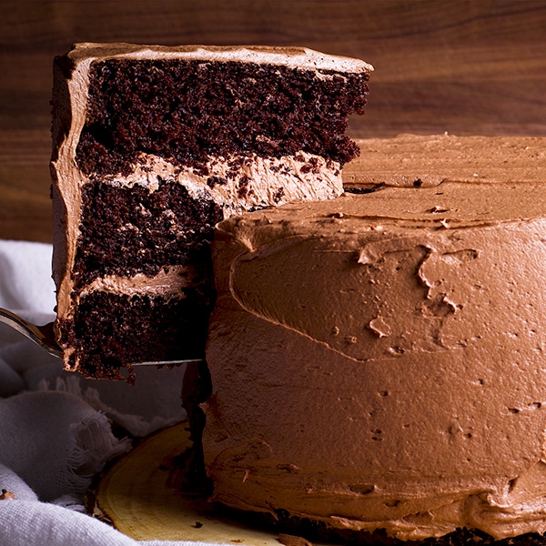 Serving a slice of three layer Chocolate Devil's Food Cake frosted with Chocolate Buttercream.