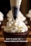 Someone piping cream cheese buttercream from a pastry bag onto the top of a chocolate cupcake.