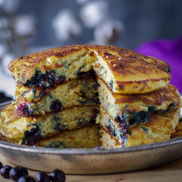 A stack of fluffy blueberry pancakes.
