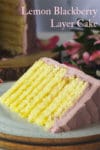 A slice of Lemon Layer Cake with Blackberry Italian Meringue Buttercream