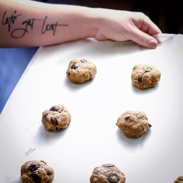 A tray of chocolate chip cookie dough ready to bake.