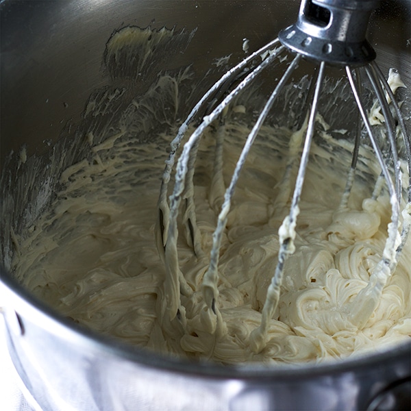 Beating American Buttercream with an electric mixer.
