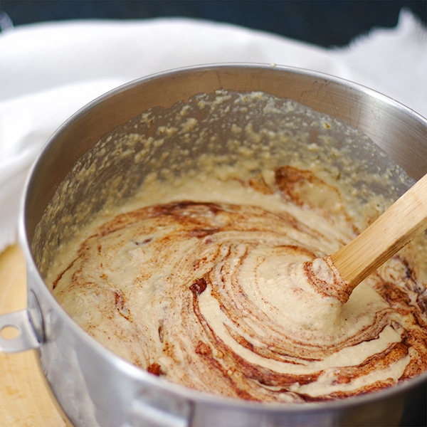 Stirring apples and brown sugar into apple cinnamon pancake batter.