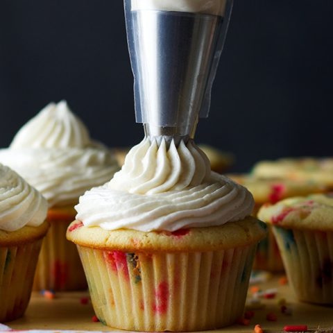 Piping American Buttercream onto Cupcakes