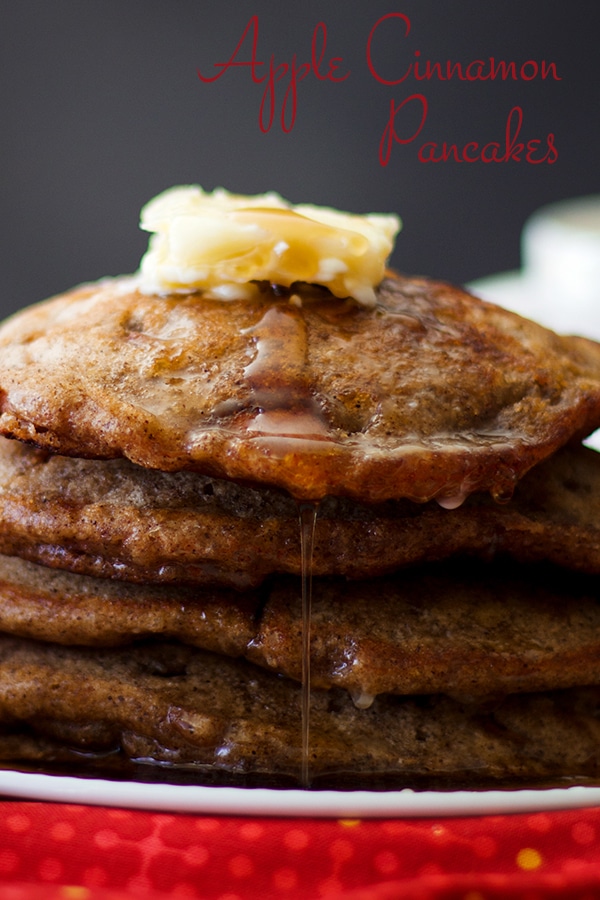 A stack of Apple Cinnamon Pancakes with butter and maple syrup.