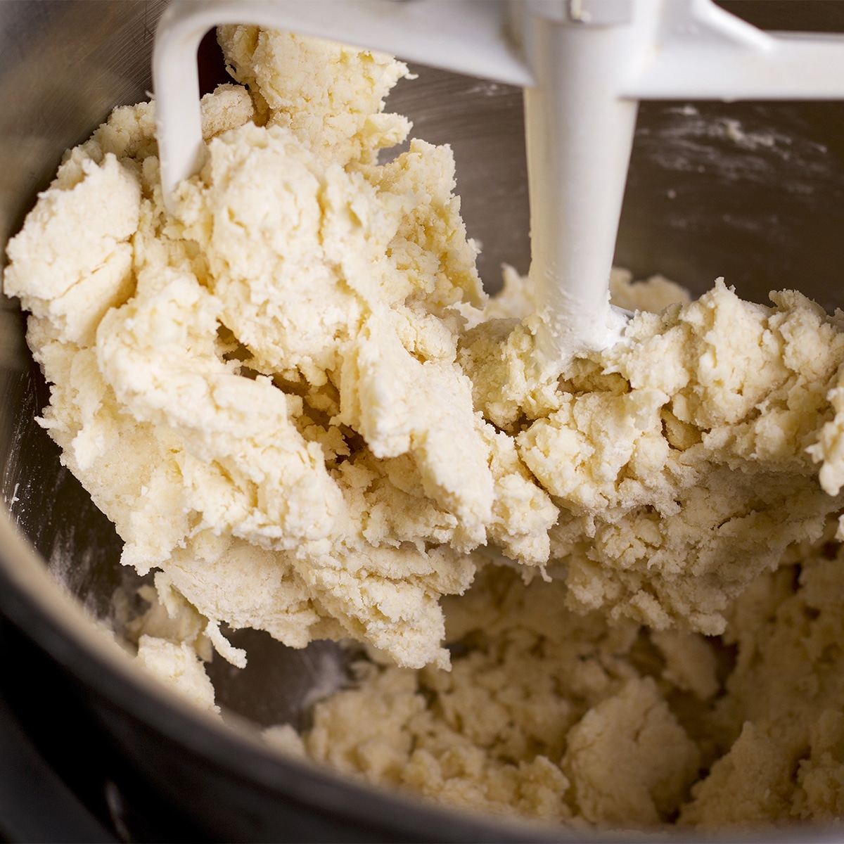 A mixing bowl containing tart crust dough.