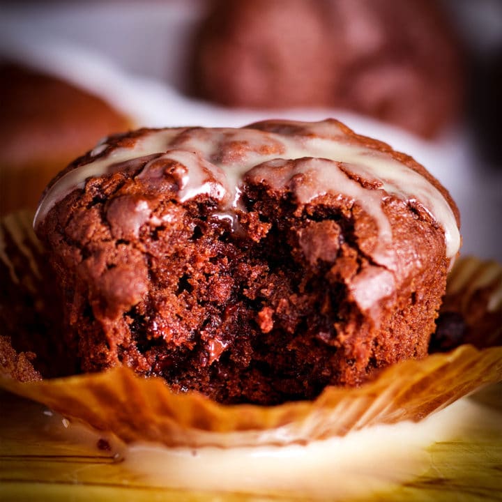A Chocolate Muffin with a bite taken out of it.