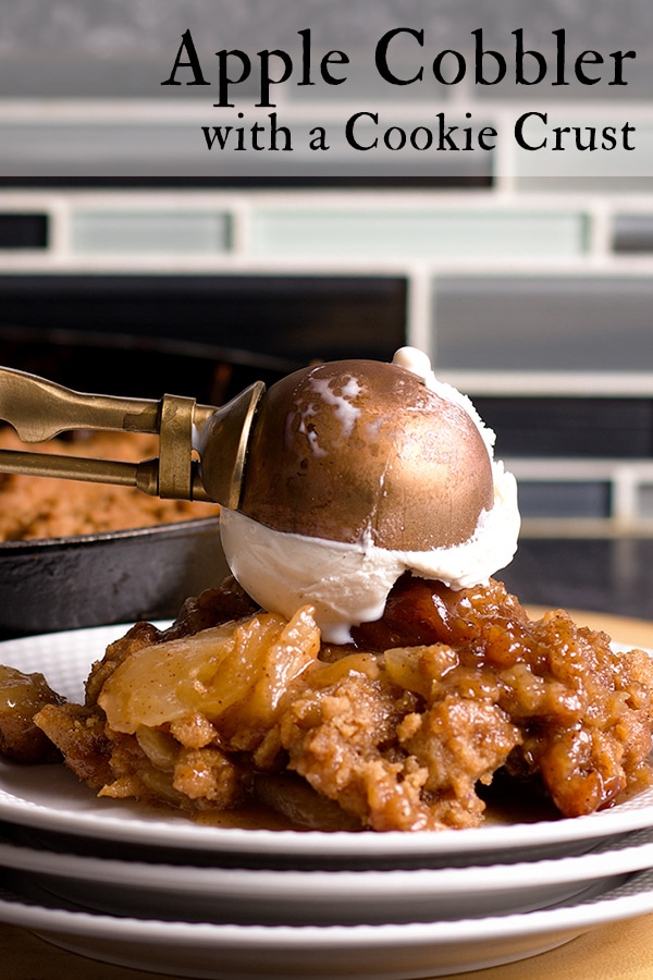 Topping a serving of Apple Cobbler with a scoop of Vanilla Ice Cream.