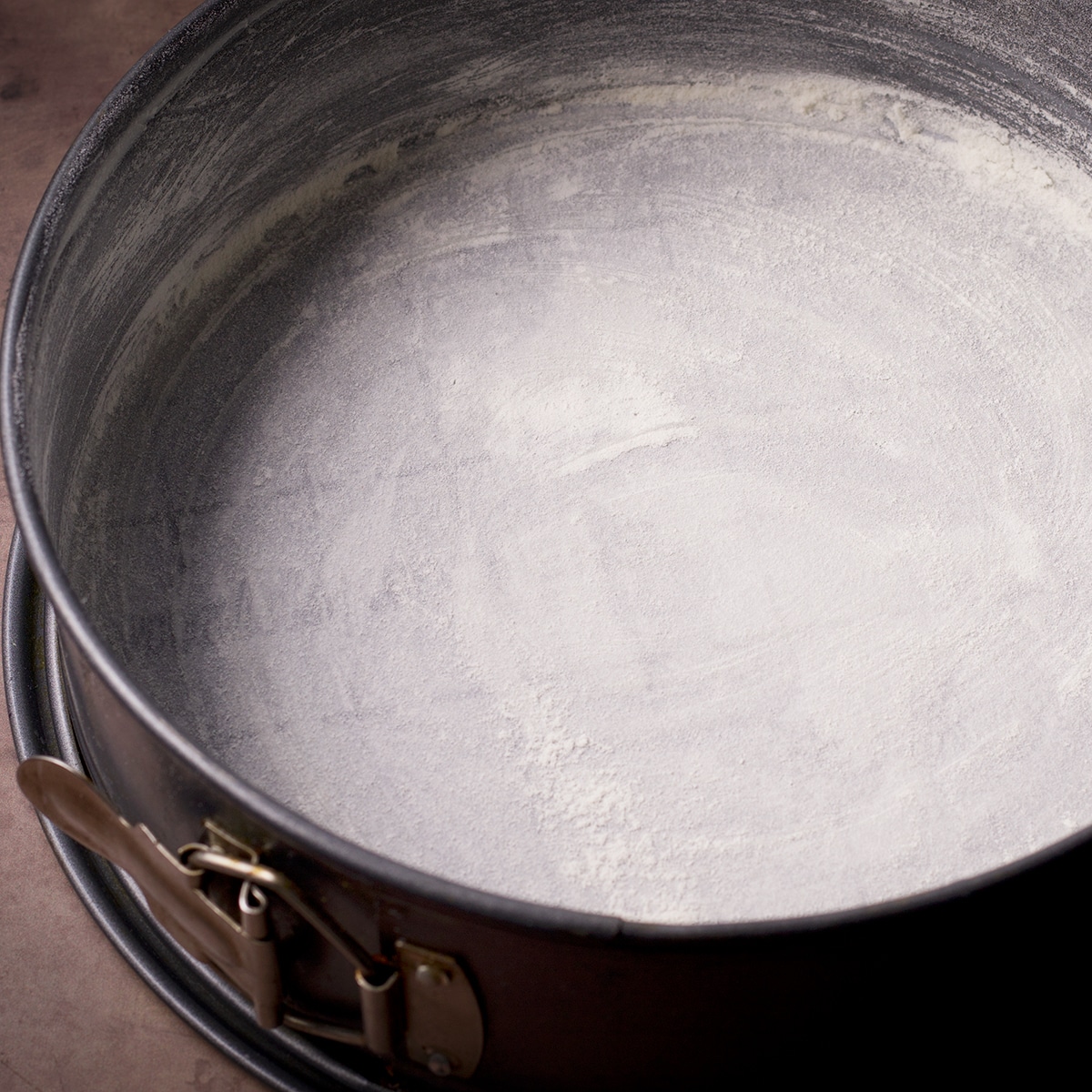 A springform pan that's been greased and floured and the bottom of the pan lined with parchment paper.