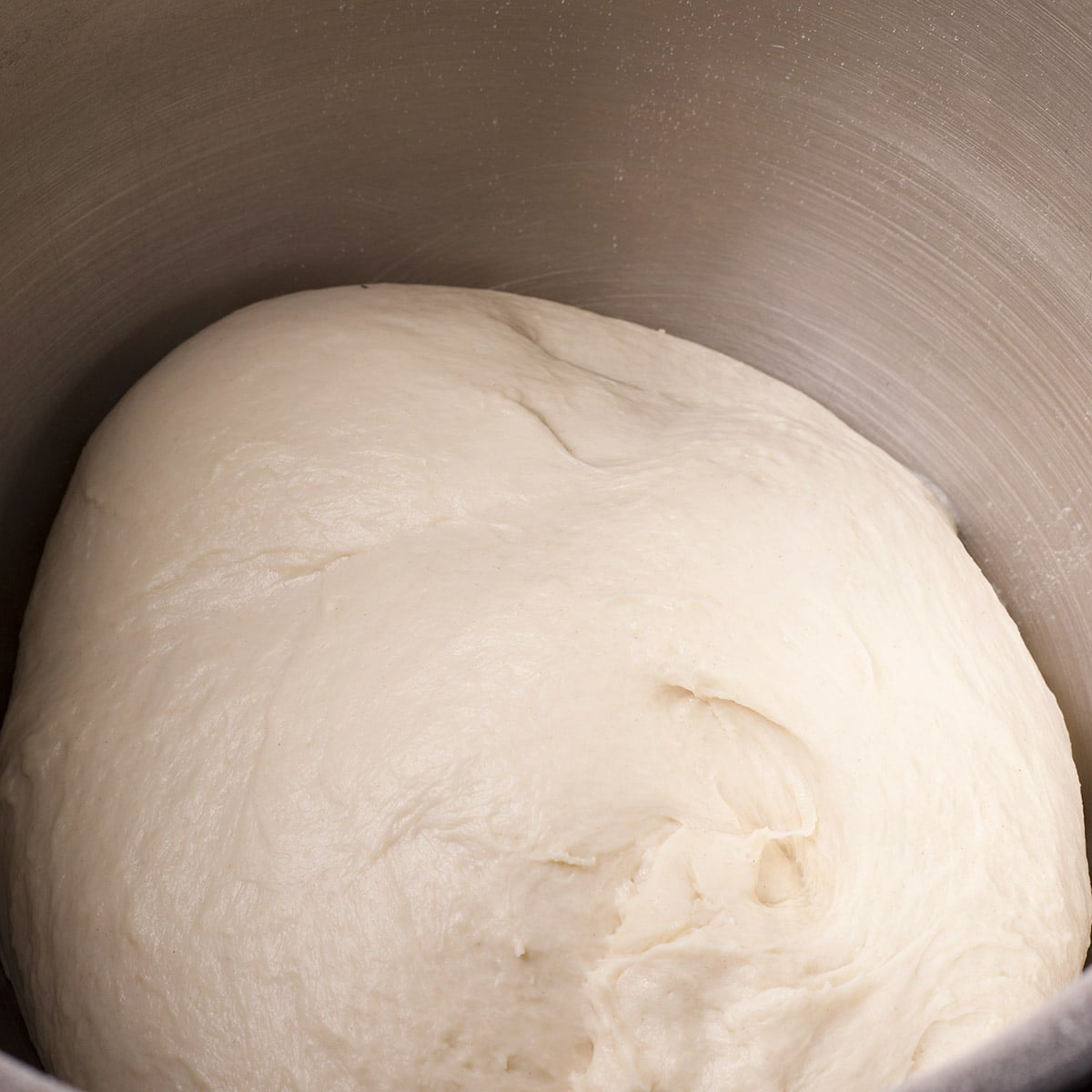 After allowing the dough to knead for 8 to 10 minutes, it should look smooth and soft, but not sticky.