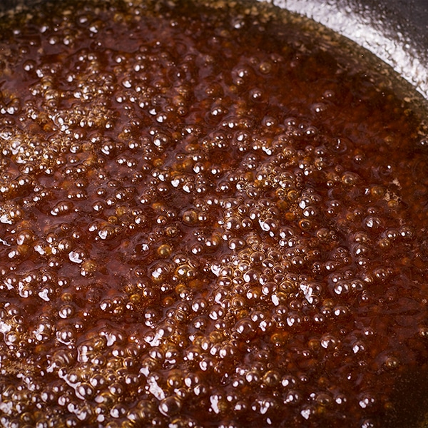 Cooking brown butter maple sauce for roasted fruit.