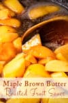 Using a wooden spoon to stir maple brown butter roasted fruit sauce as it cooks.