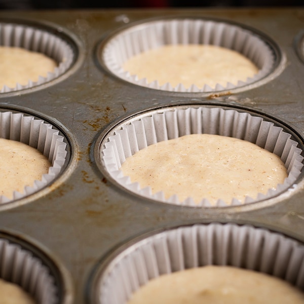Filling a cupcake pan with the batter for hummingbird cupcakes.