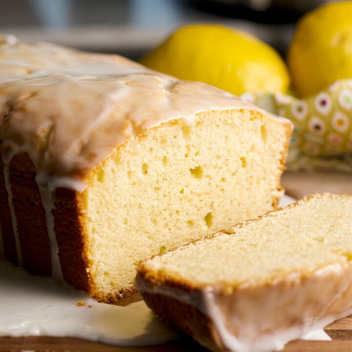 A lemon loaf cake with a few slices cut from the cake.