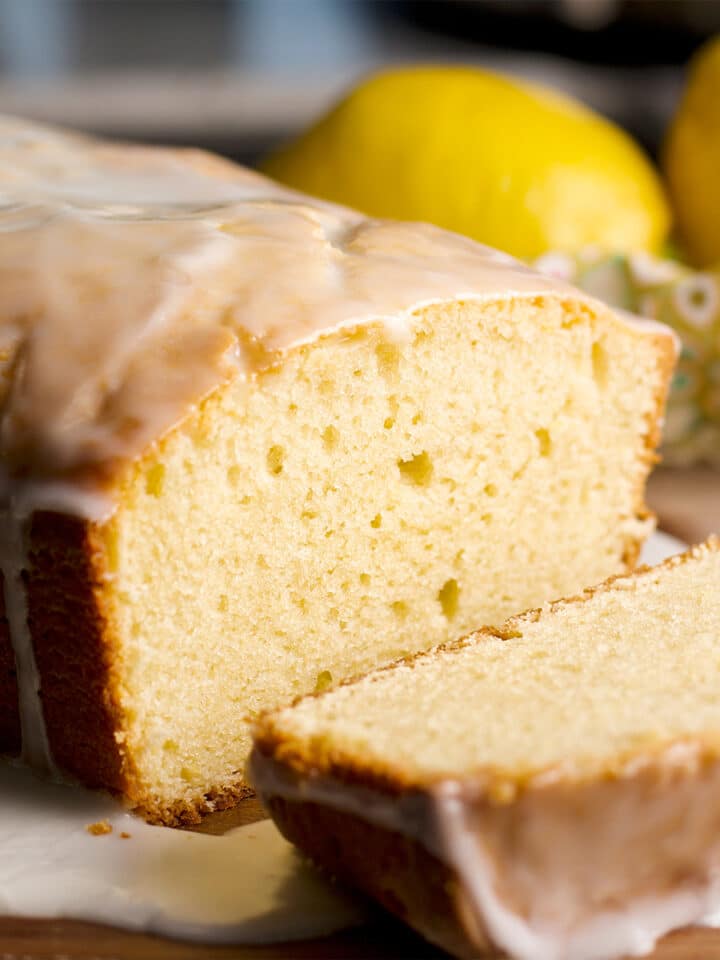A lemon loaf cake with a few slices cut from the cake.