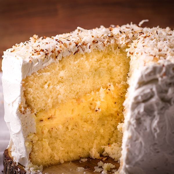 The inside of a two layer coconut cream cake filled with coconut cream and frosted with coconut buttercream.
