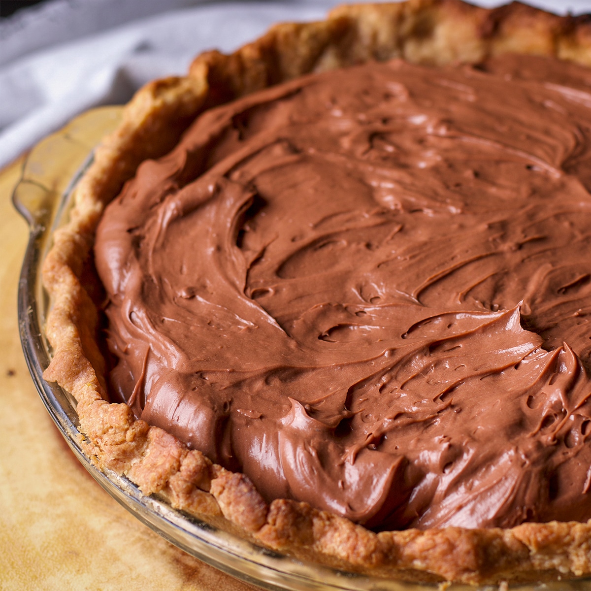 A baked toasted almond pie crust filled with chocolate pastry cream.