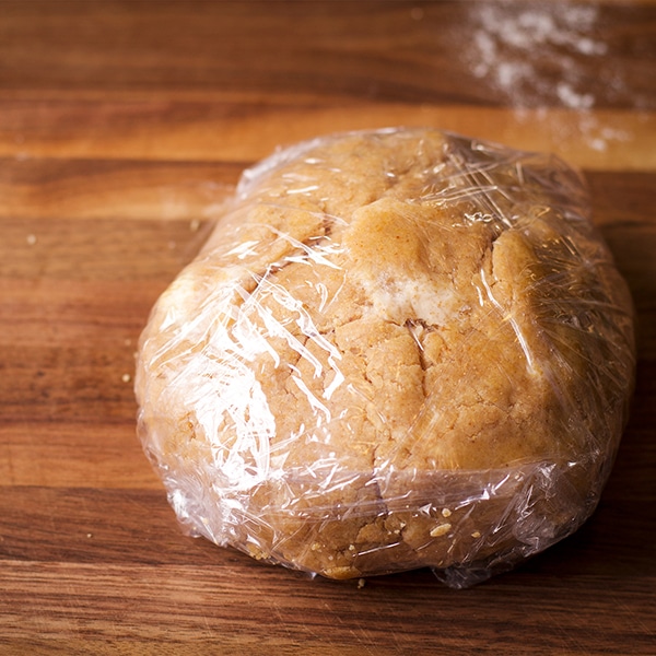 A wrapped ball of toasted almond pie crust dough.