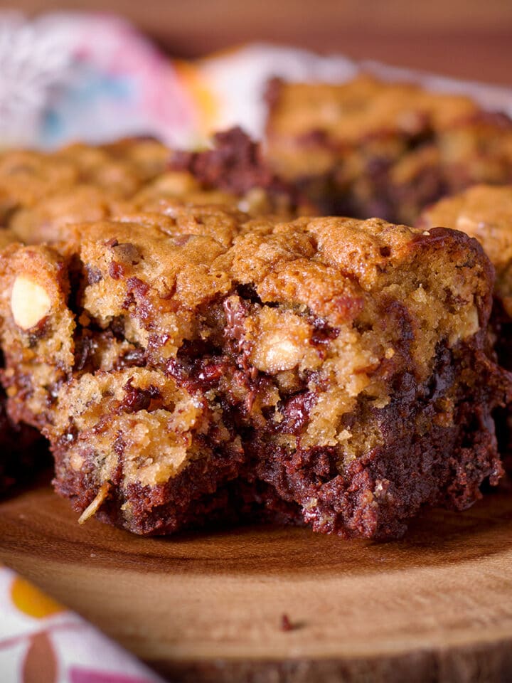 A tray of gooey chocolate chip cookie brownie bars.