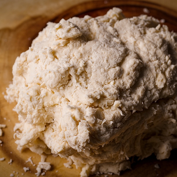 The dough for buttermilk biscuits on a work surface, ready to be rolled out.