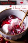 A bowl of vanilla ice cream topped with homemade cherry sauce.