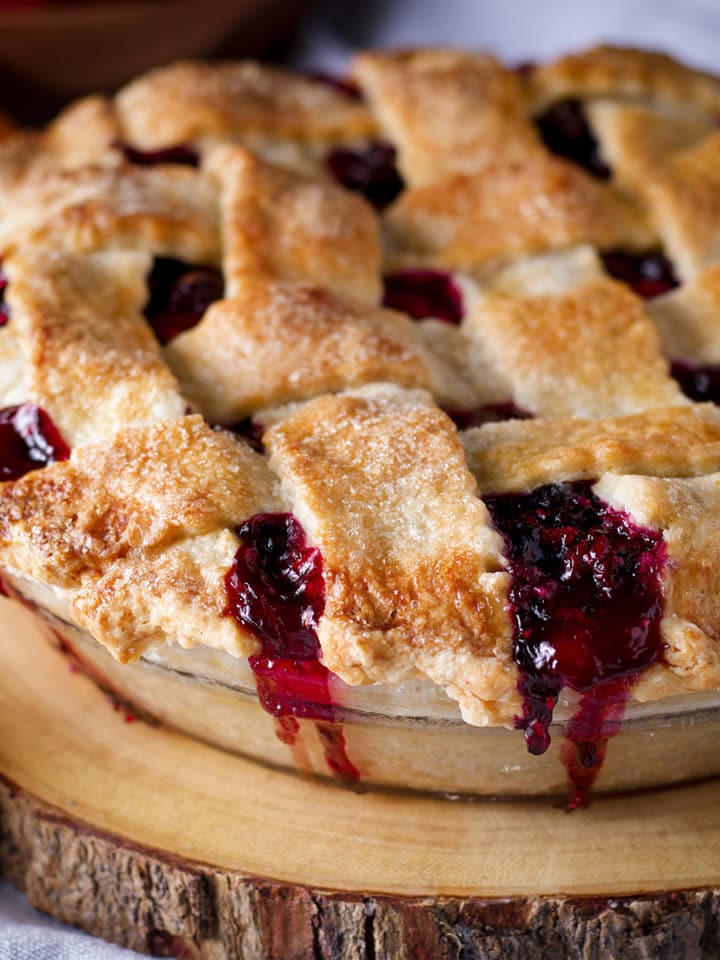 A berry pie with a flaky lattice crust that's been dusted with sugar.