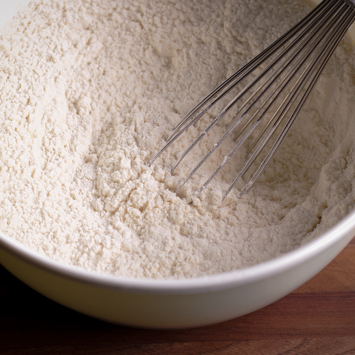 Stirring the dry ingredients for New York Cheesecake crust with a wire whisk.
